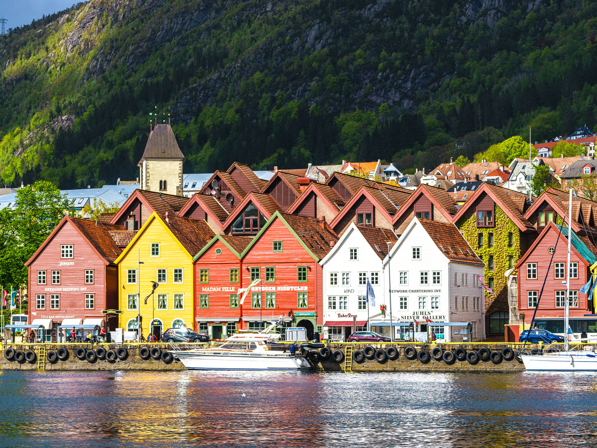 Colorful waterfront buildings against mountainous backdrop in Bergen, Norway