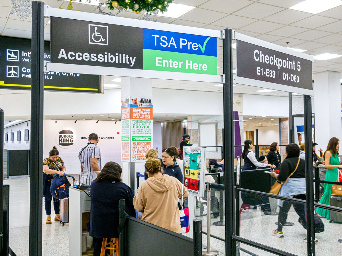 Travelers passing through TSA PreCheck checkpoint at airport