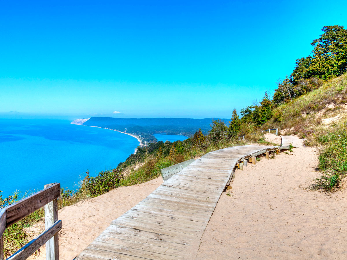 Wooden pathway over sand overlooking lake at Sleeping Bear Dunes National Lakeshore in Michigan