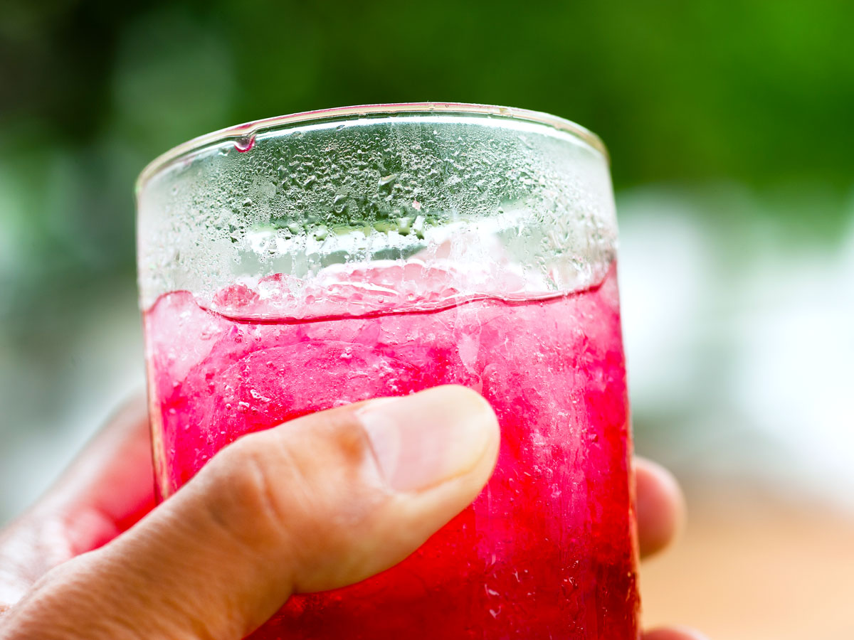 Person holding glass of Kool-Aid