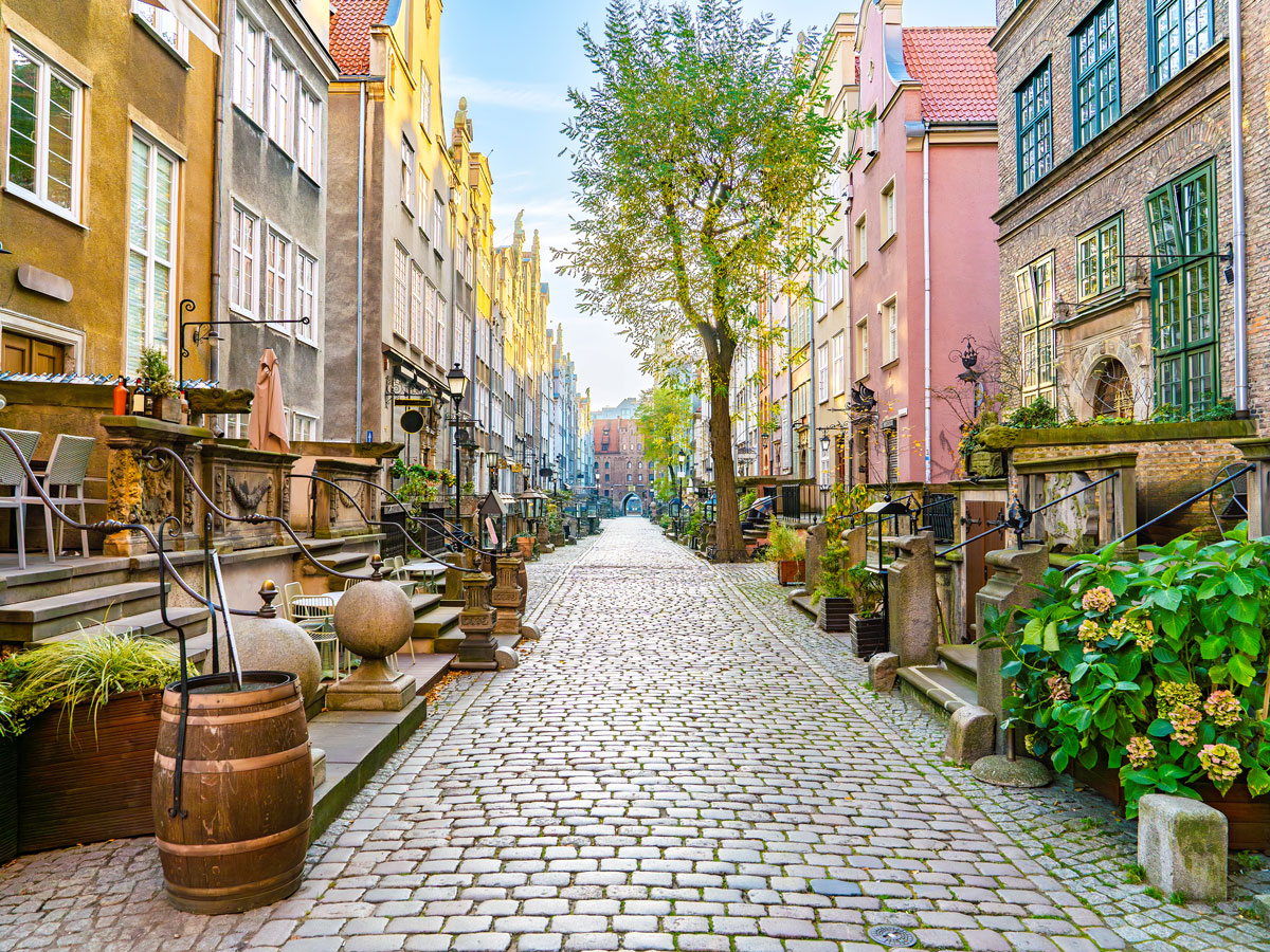 Cobblestone lane between colorful buildings in Gdańsk, Poland