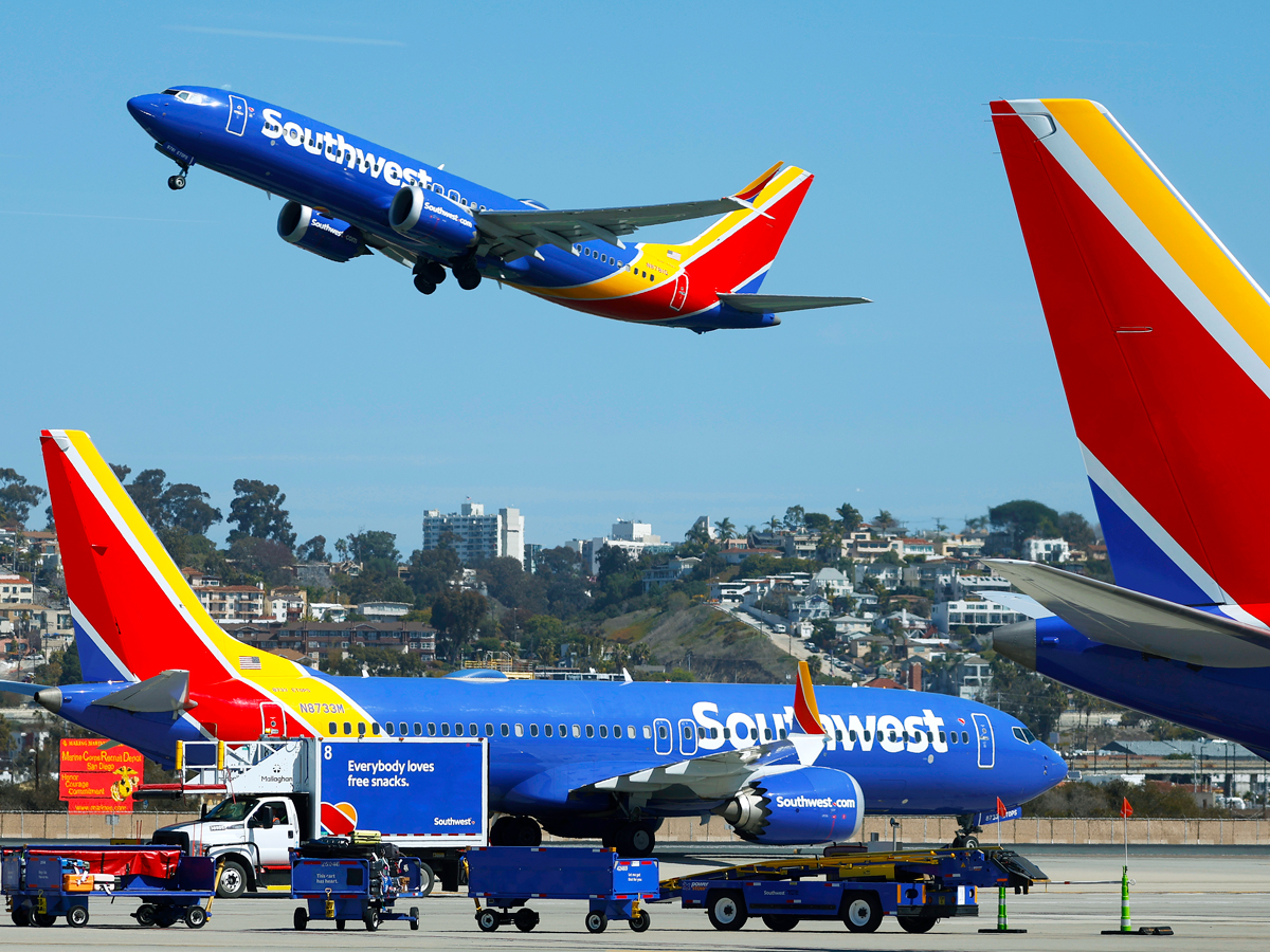Southwest Airlines Boeing 737 taking off as another taxies by
