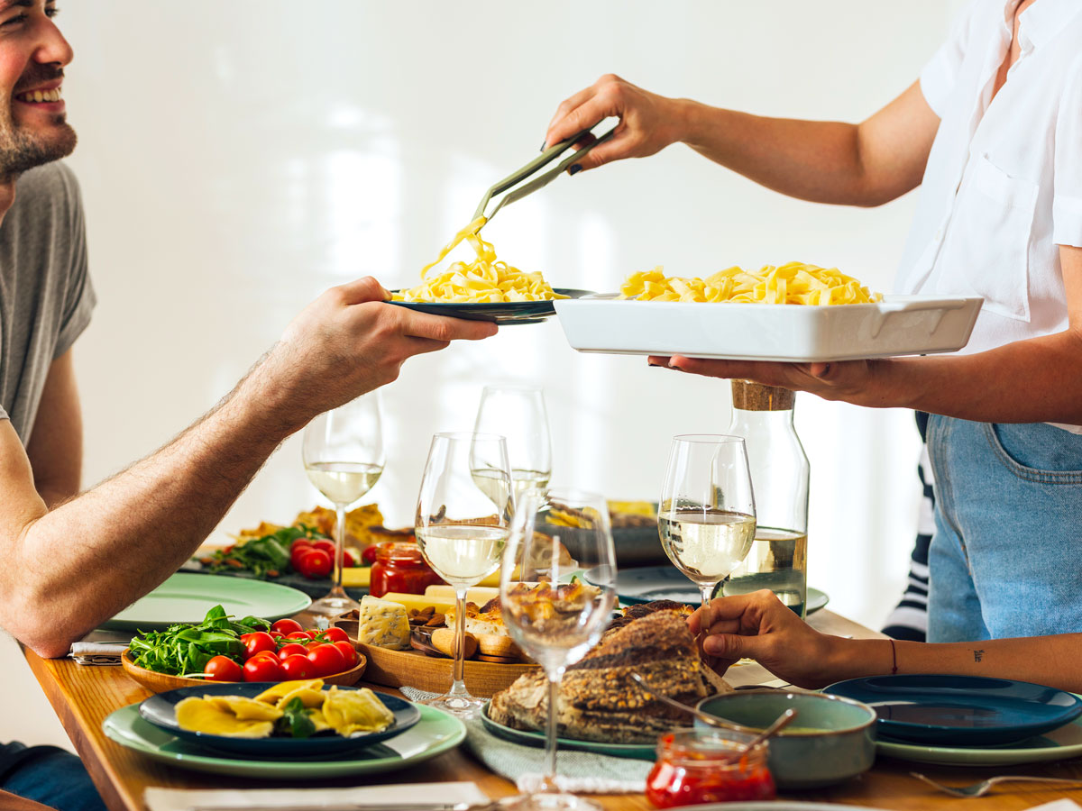 Host serving dinner to guests