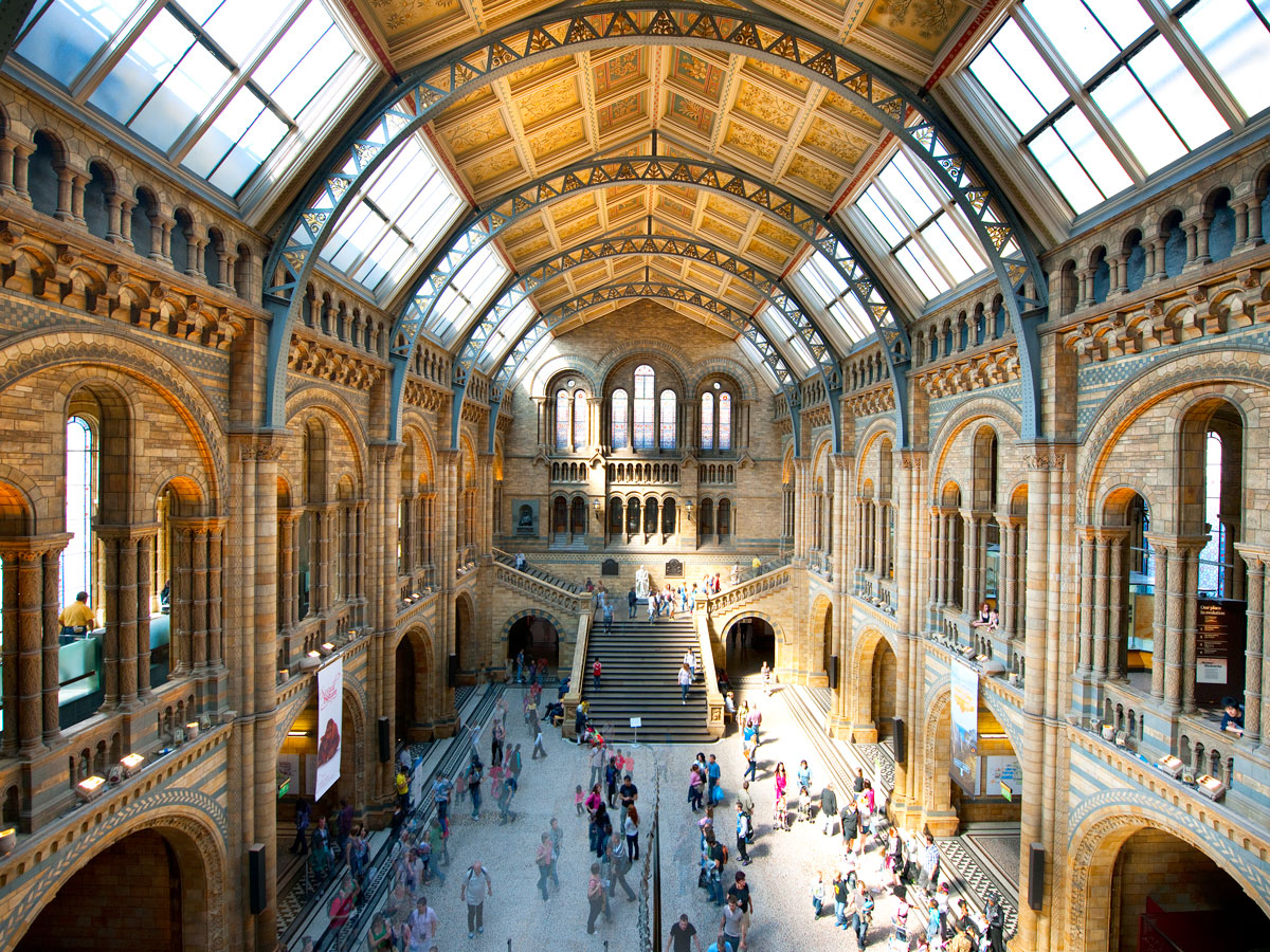 Visitors inside light-filled hall of the Natural History Museum in London, England
