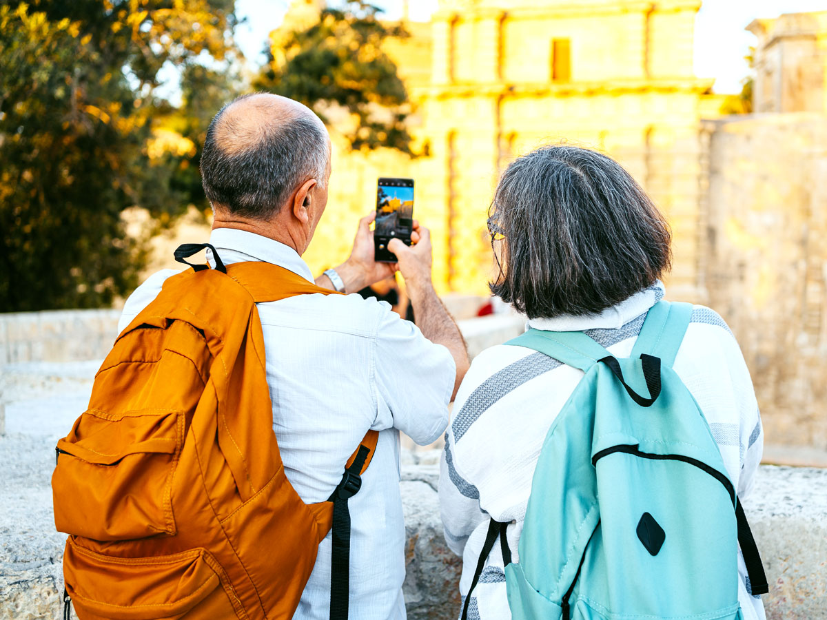 Tourists taking photo of Mdina Gate in Malta