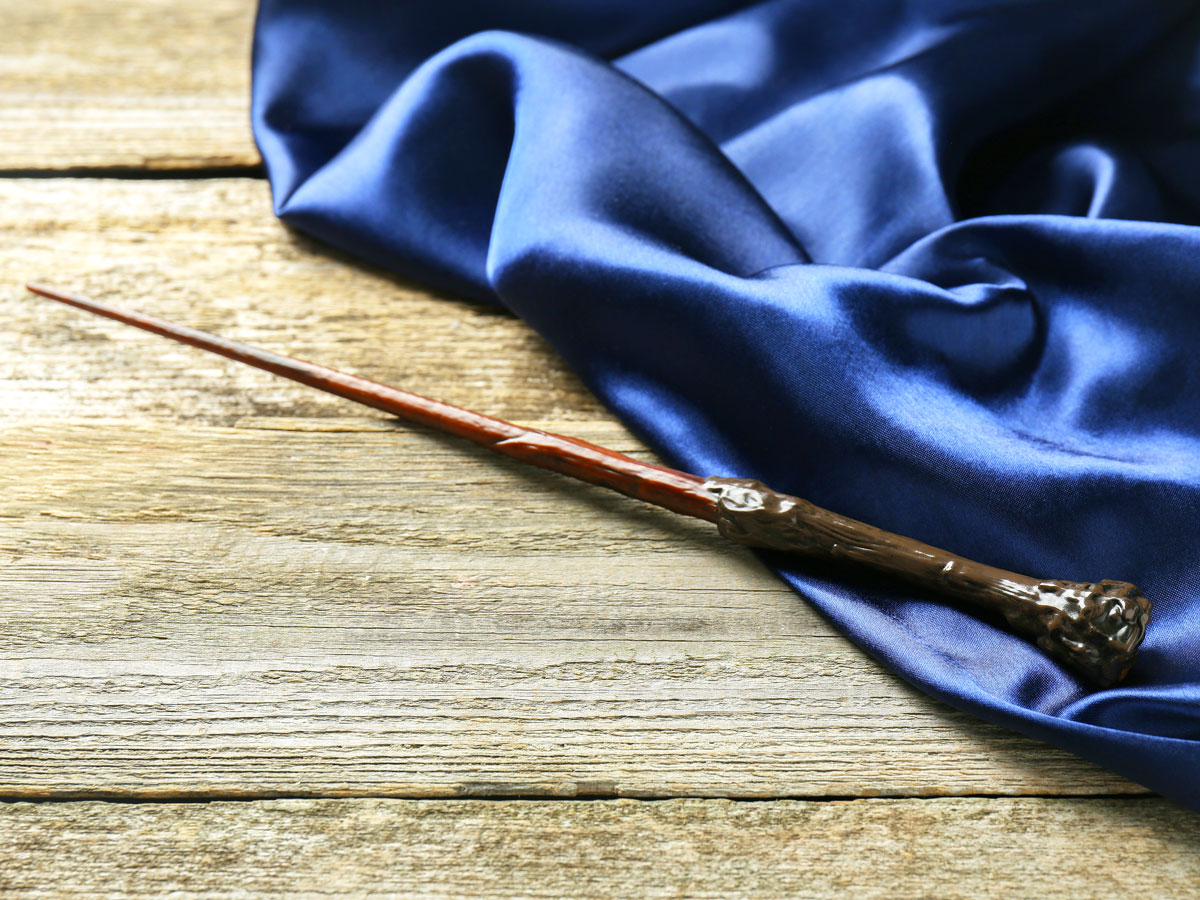 A toy wand sitting on a wooden table