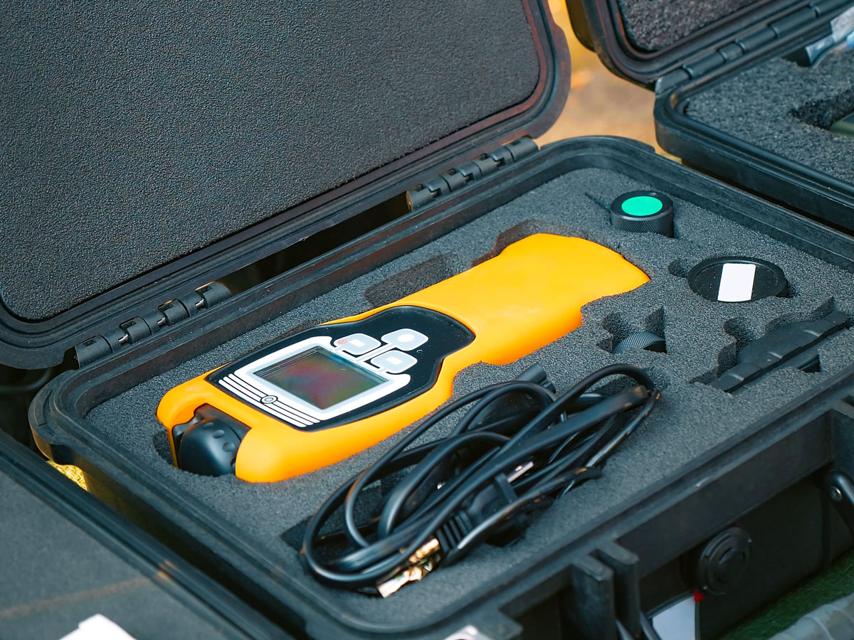 A yellow radiation-measuring device in its box