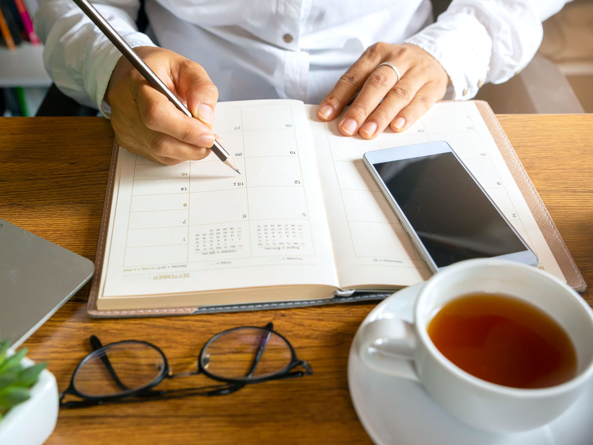 Person writing in calendar