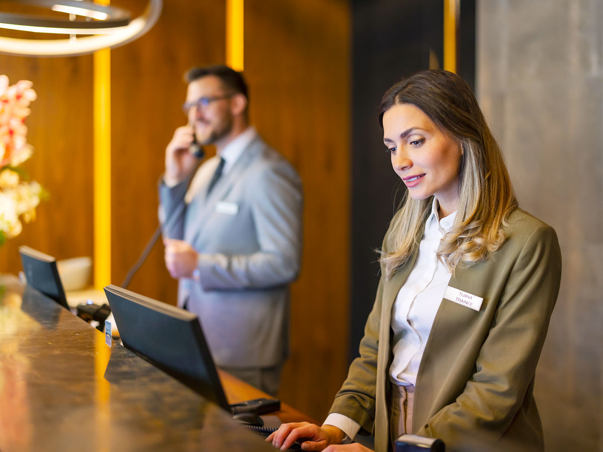 Employees working at hotel front desk