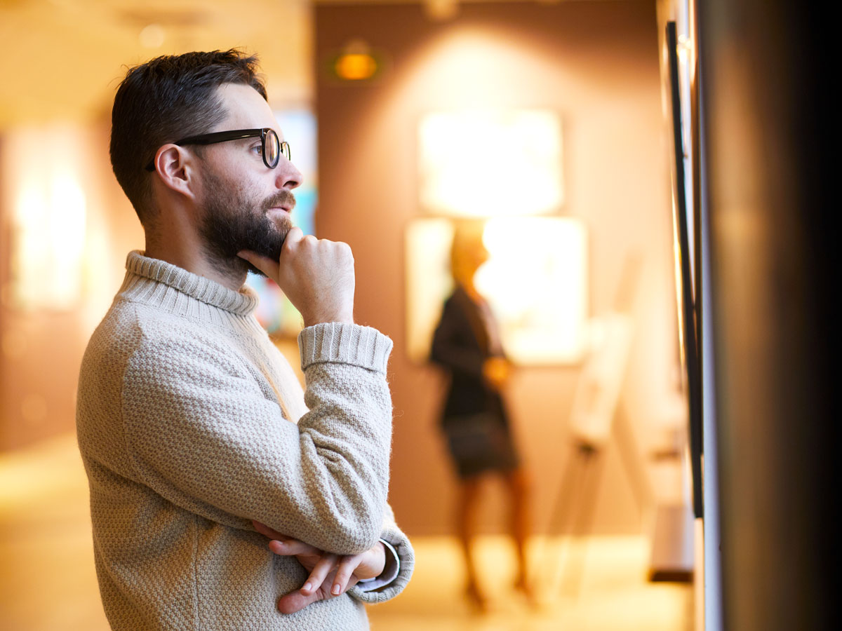 Museum visitor contemplating painting