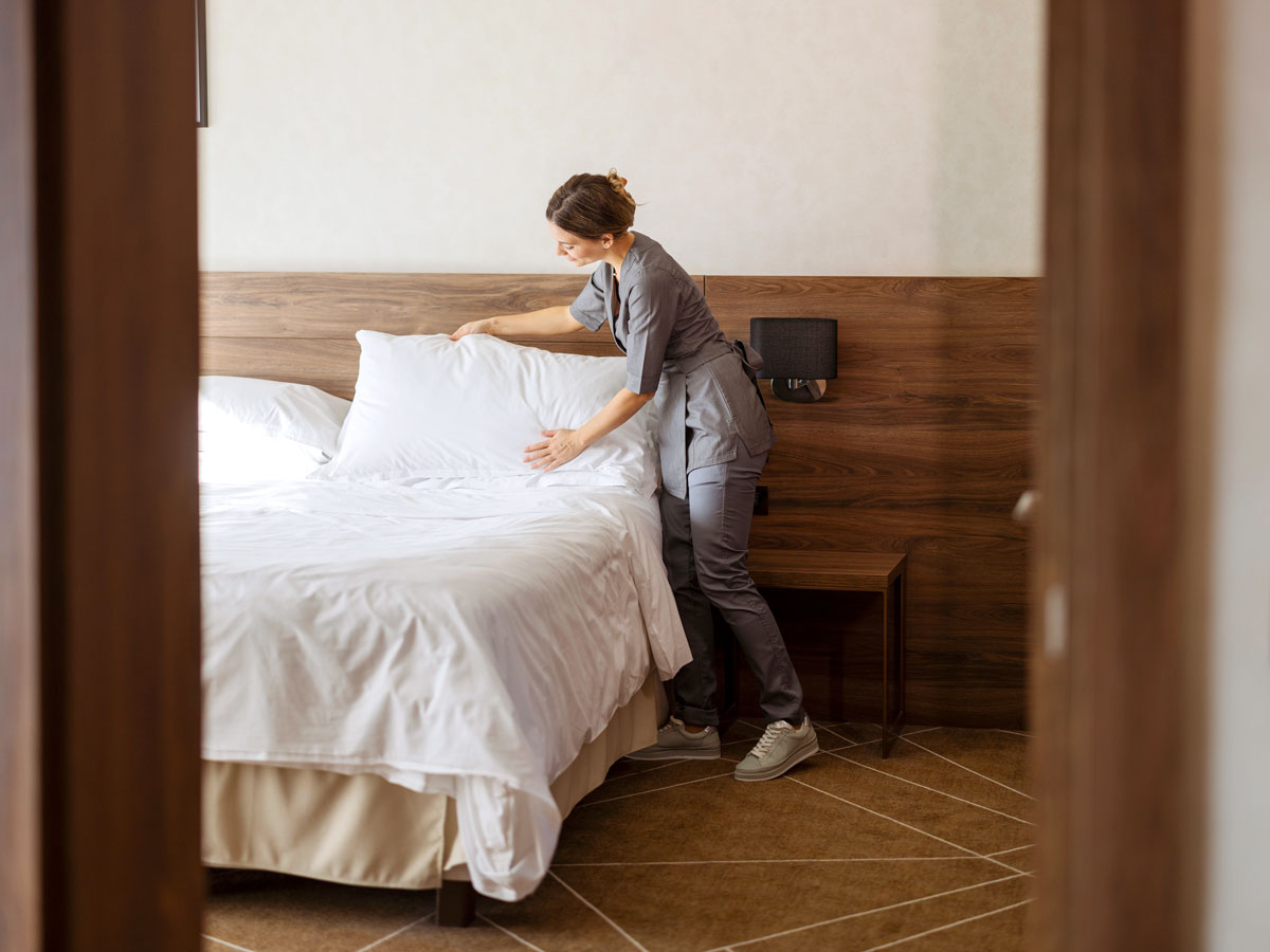 Hotel housekeeping staff making bed