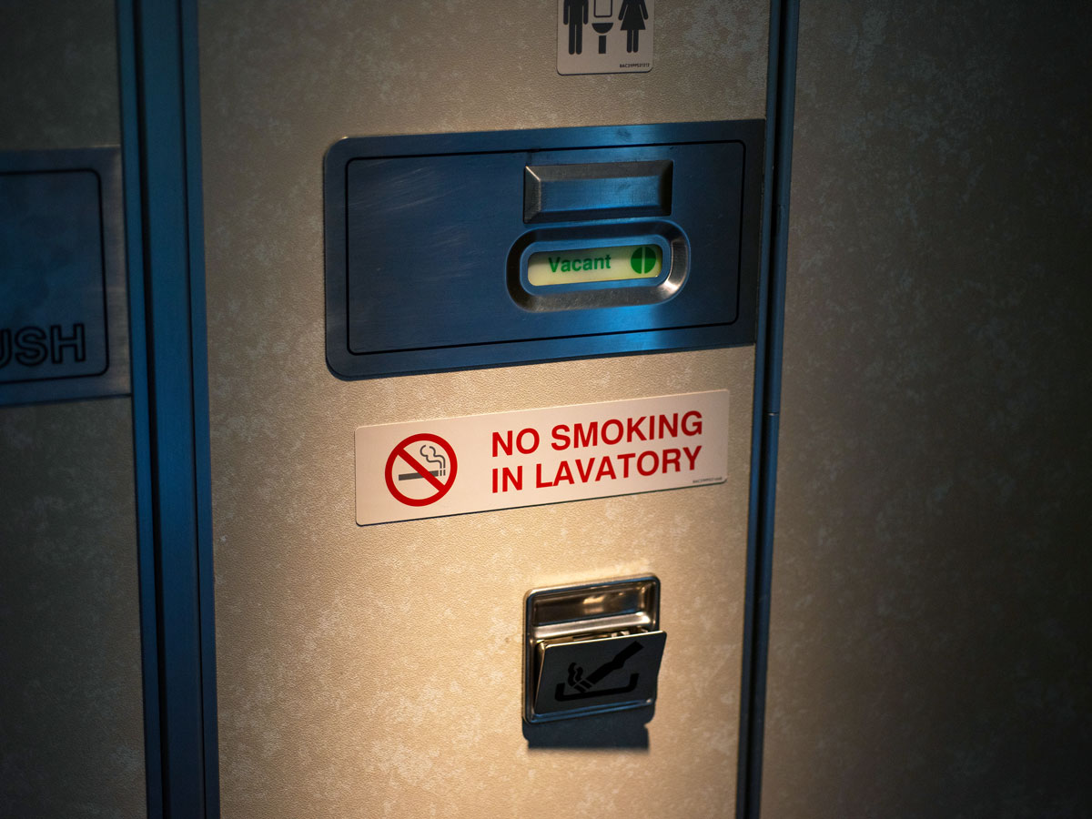 Lavatory door on aircraft with no-smoking sign