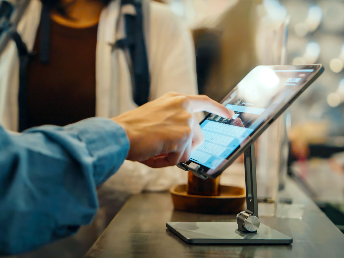 Hotel guest using self-service kiosk
