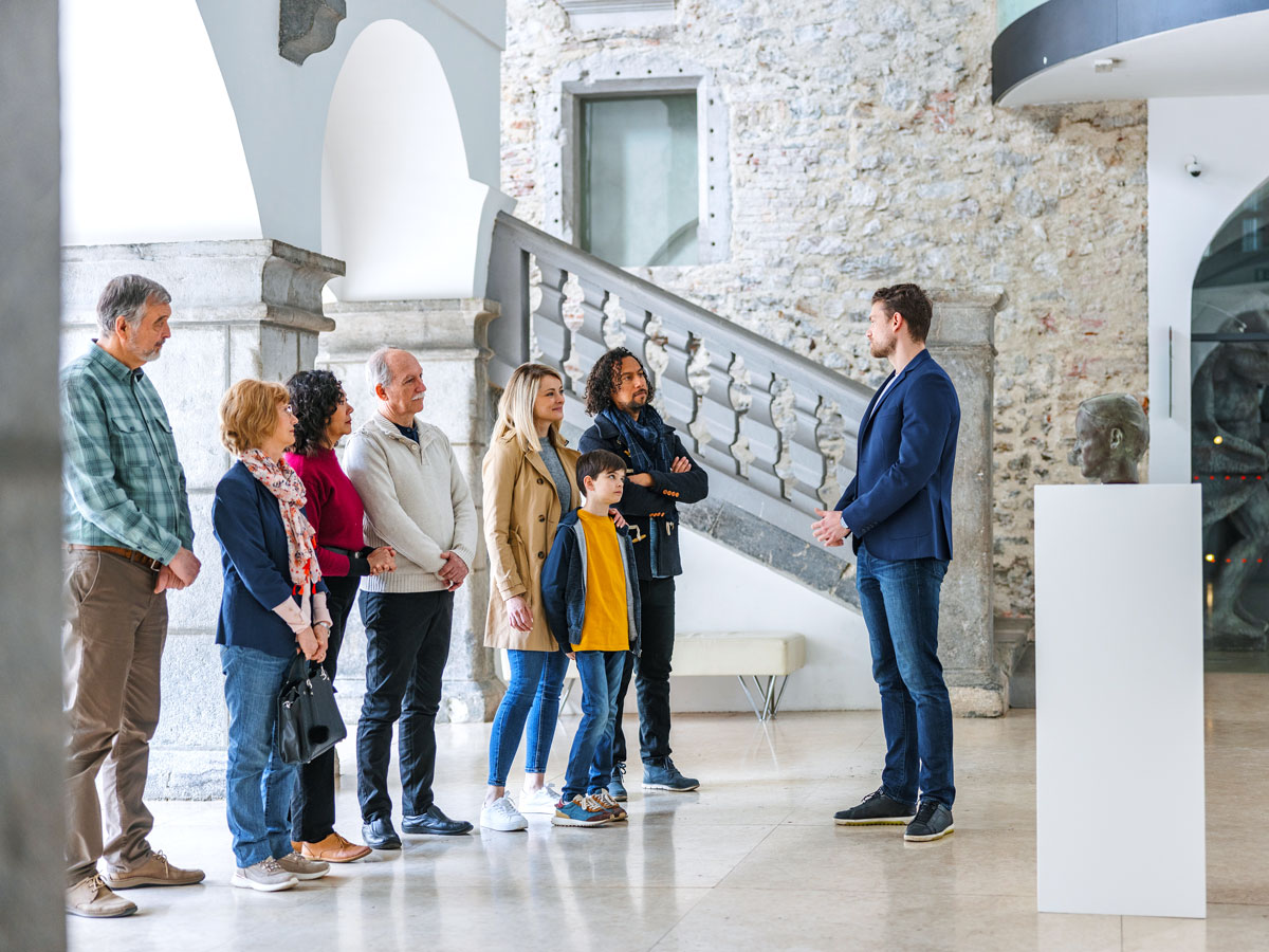 Museum guests listening to tour guide