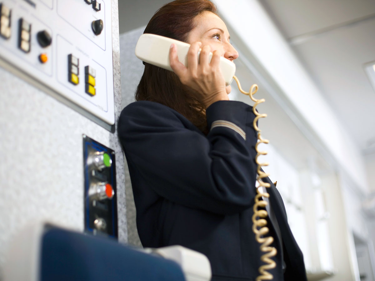 Flight attendant making announcement on aircraft PA system