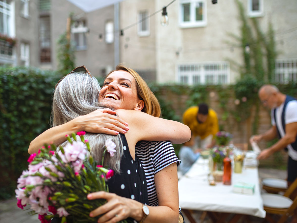 Two people hugging in backyard