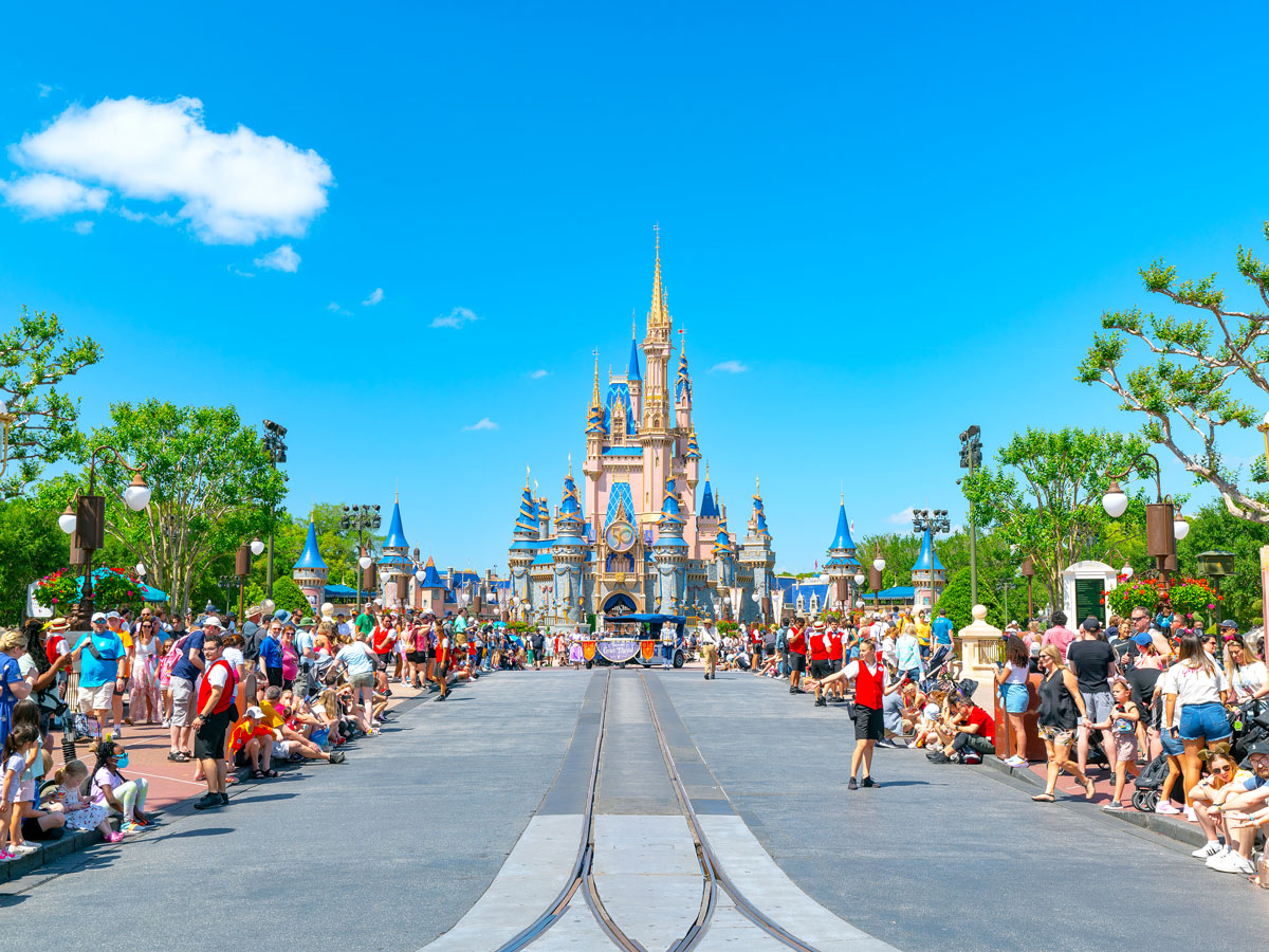Crowds form along parade route toward Cinderella's Castle at Walt Disney World in Florida