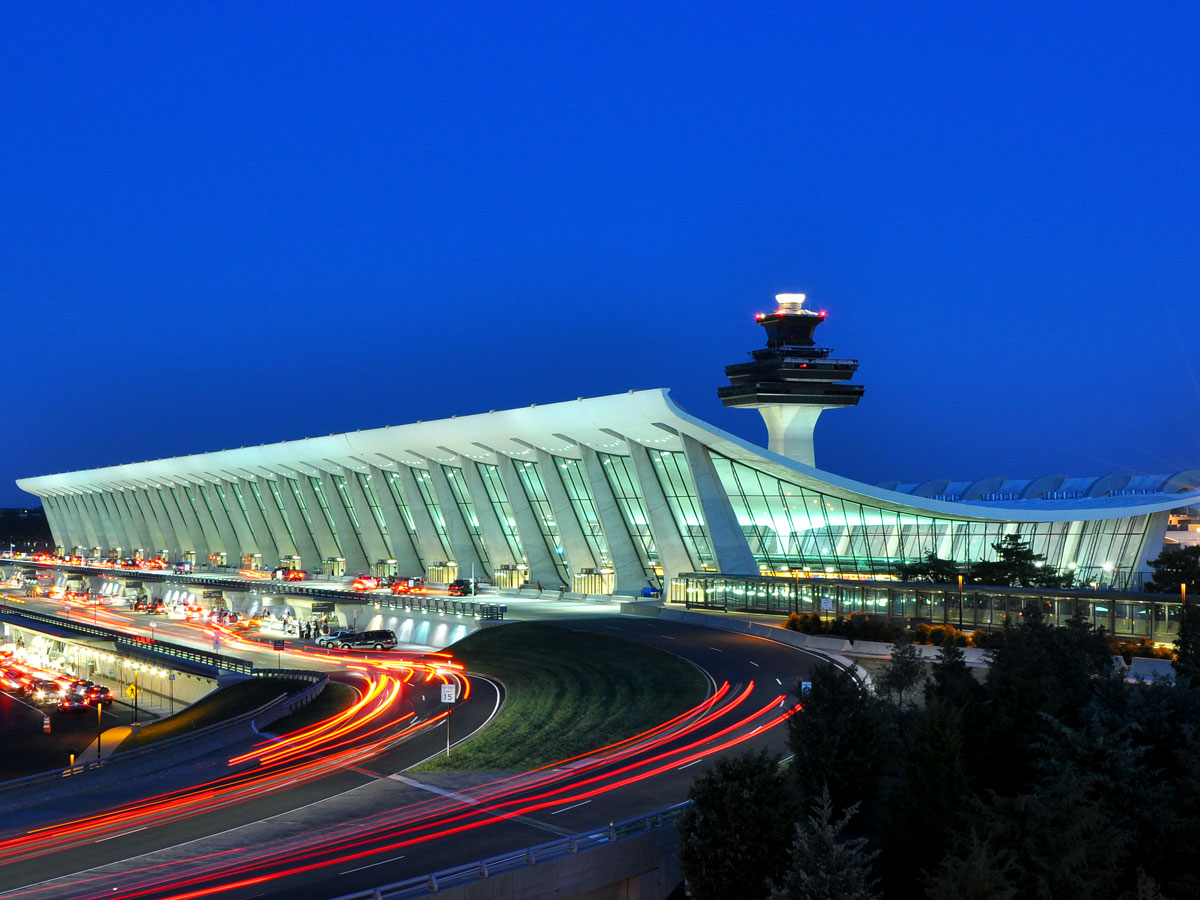 Main terminal building and control tower at Washington Dulles International Airport illuminated at night