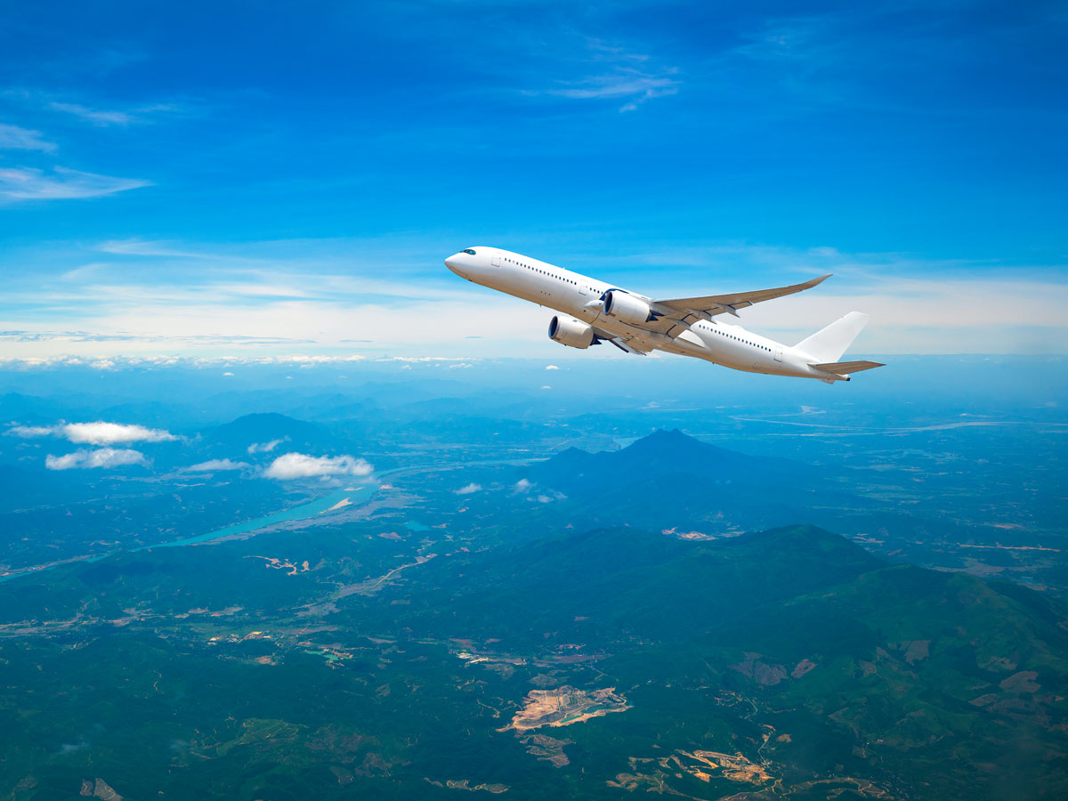 Airplane ascending over mountains