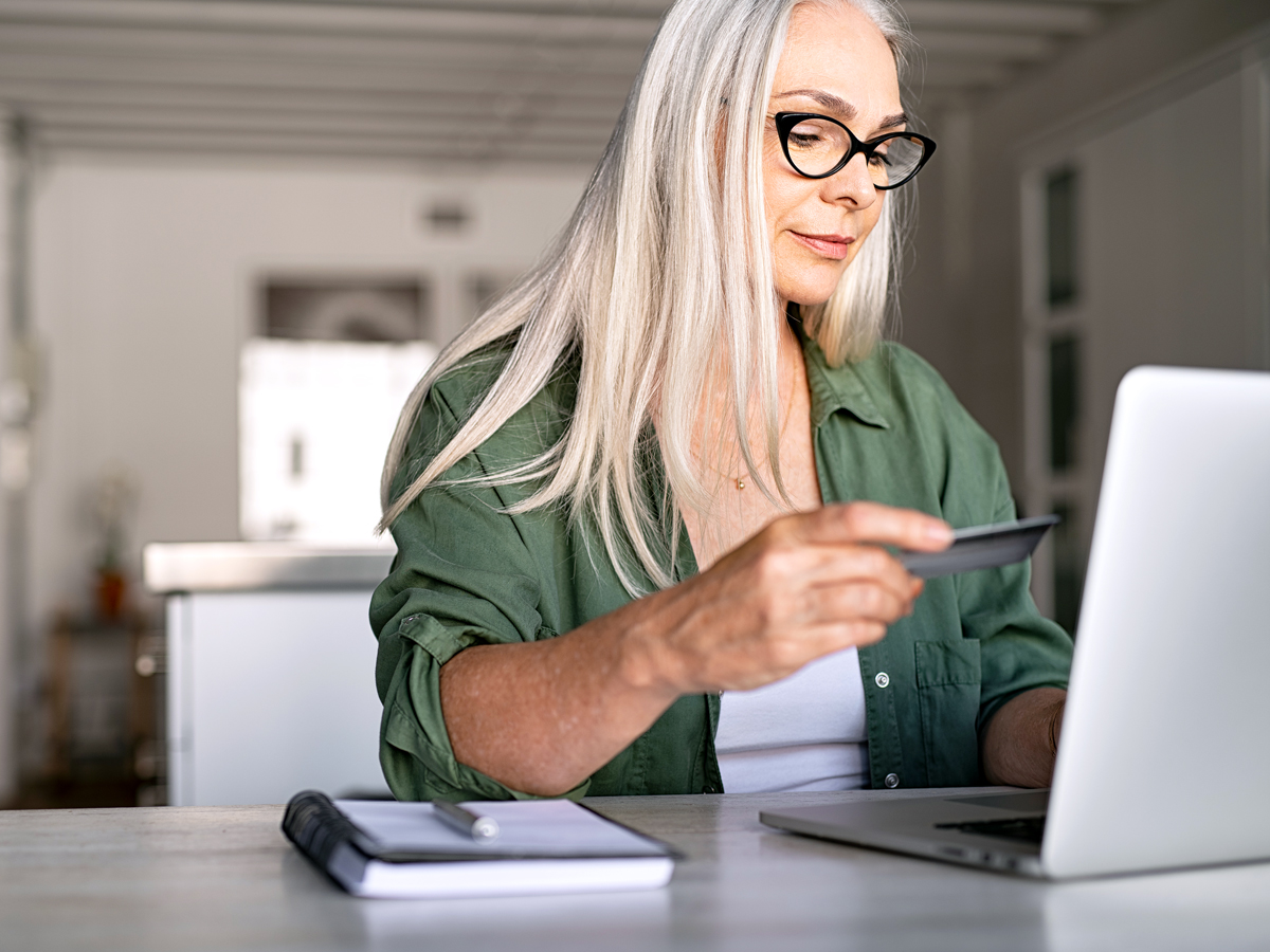 Woman using credit card to make online purchase