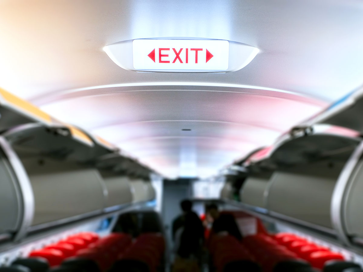 Illuminated exit sign in aircraft cabin