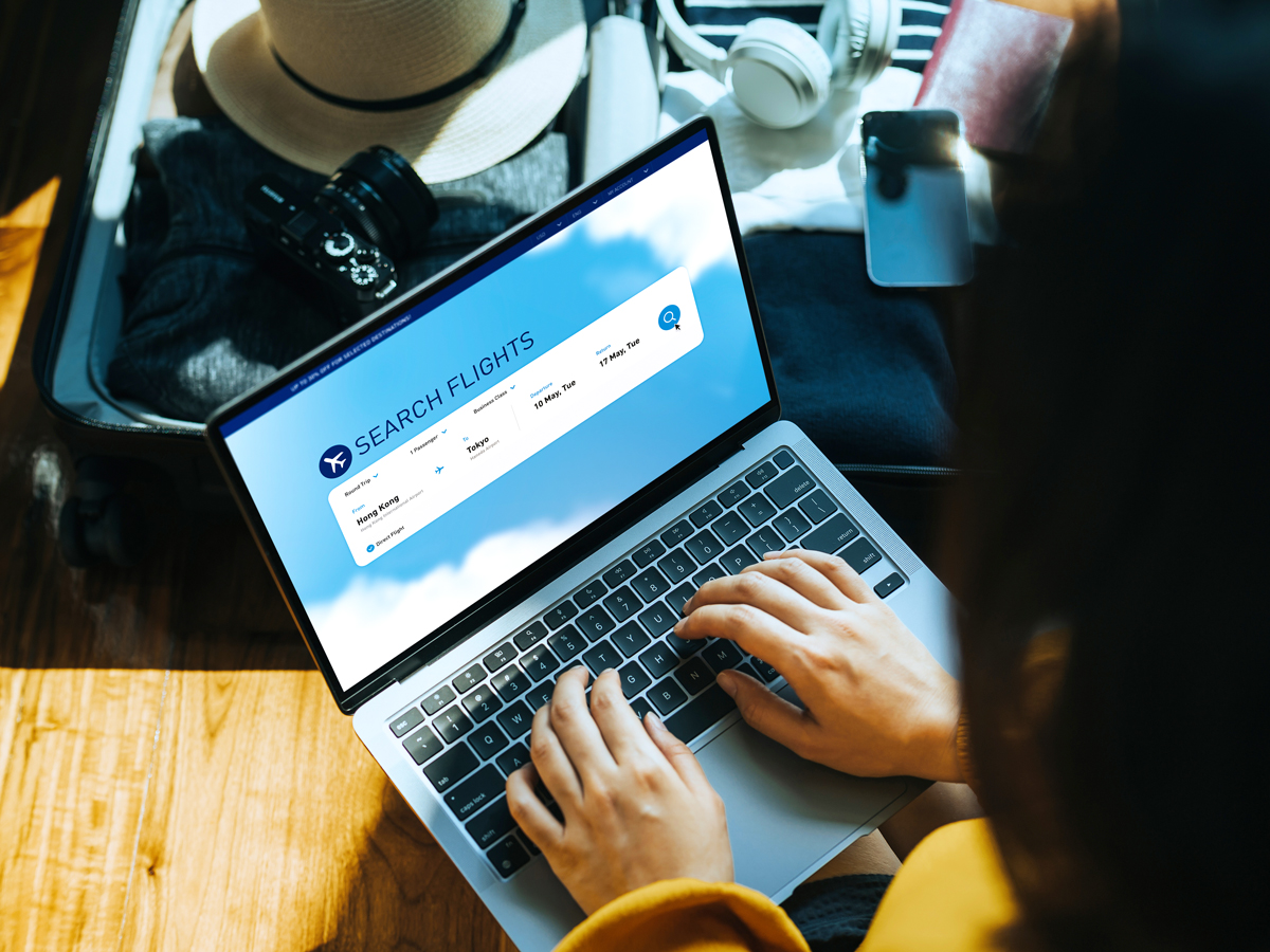Person searching for flights on laptop computer