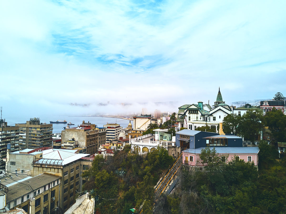 Fog rolling in above rooftops in Valparaiso, Chile