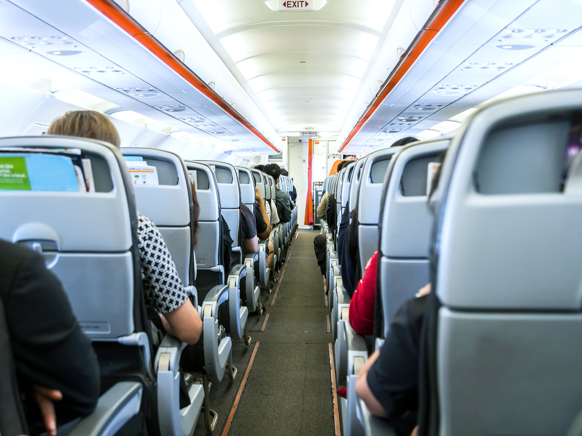 View of airplane cabin looking back to front