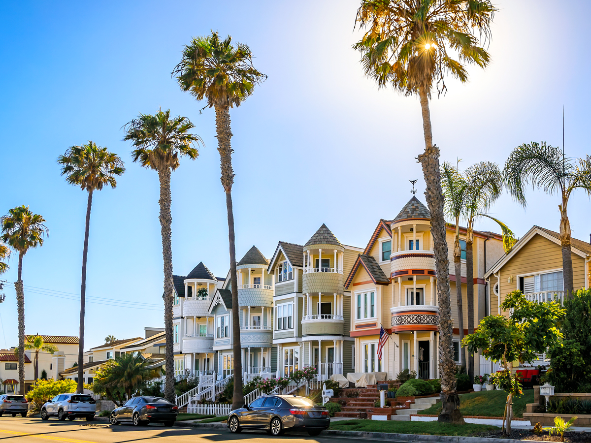 Residential street lined with palm trees in Huntington Beach, California