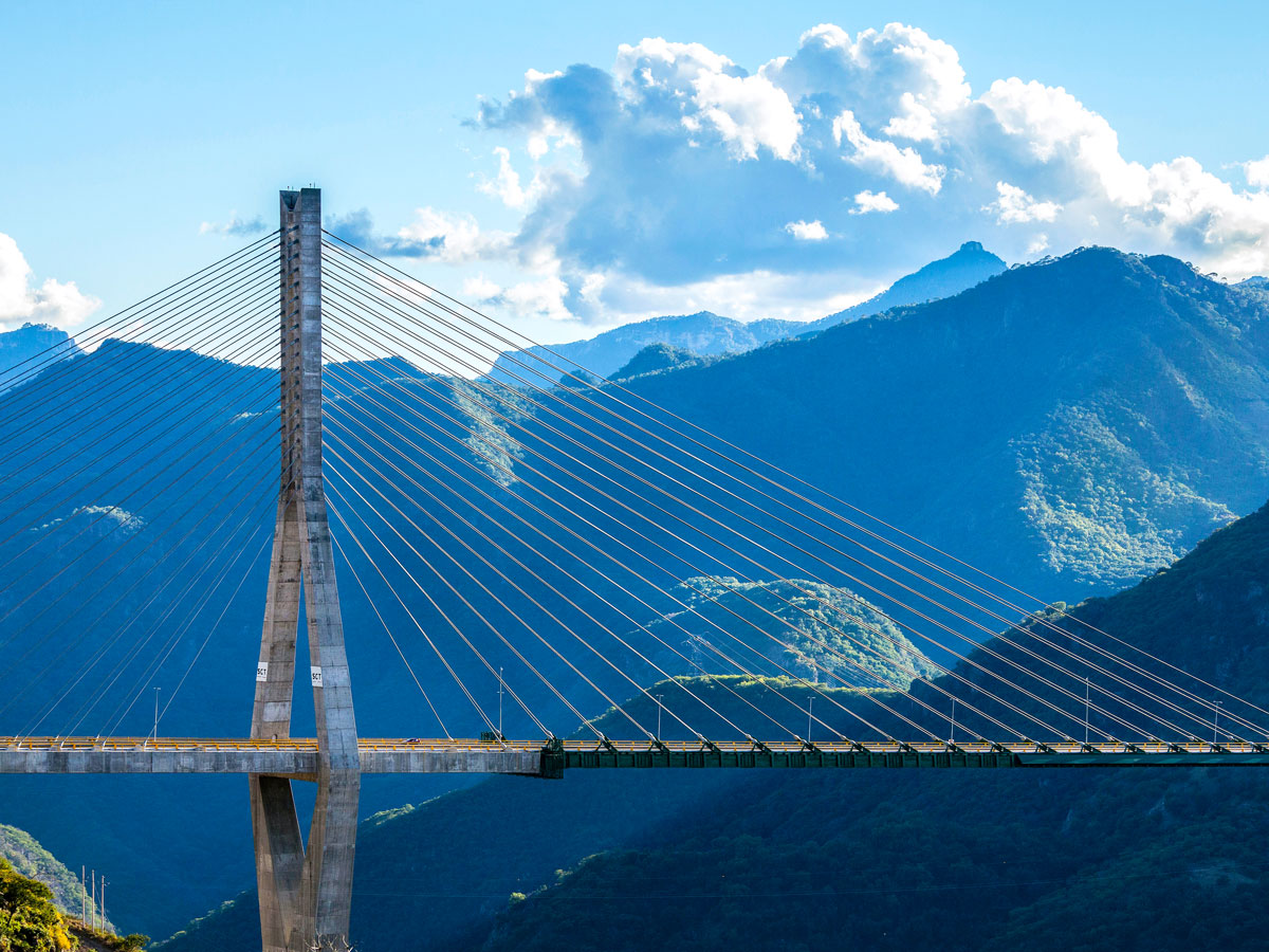 Side profile of Huajiang Grand Canyon Bridge and surrounding mountains