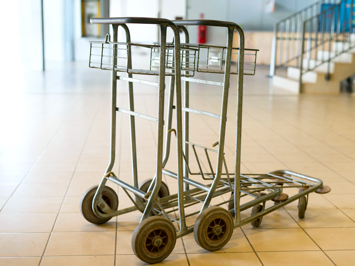 Empty luggage carts in airport terminal