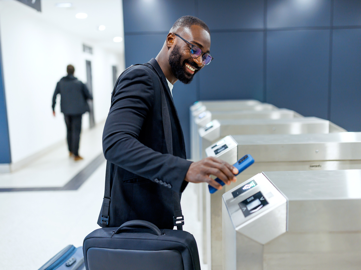 Passenger scanning boarding pass at e-gate