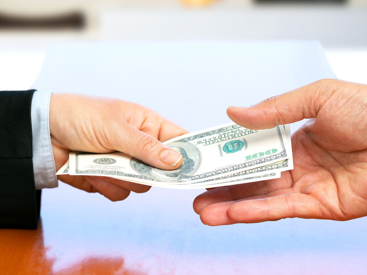 People exchanging $100 bills