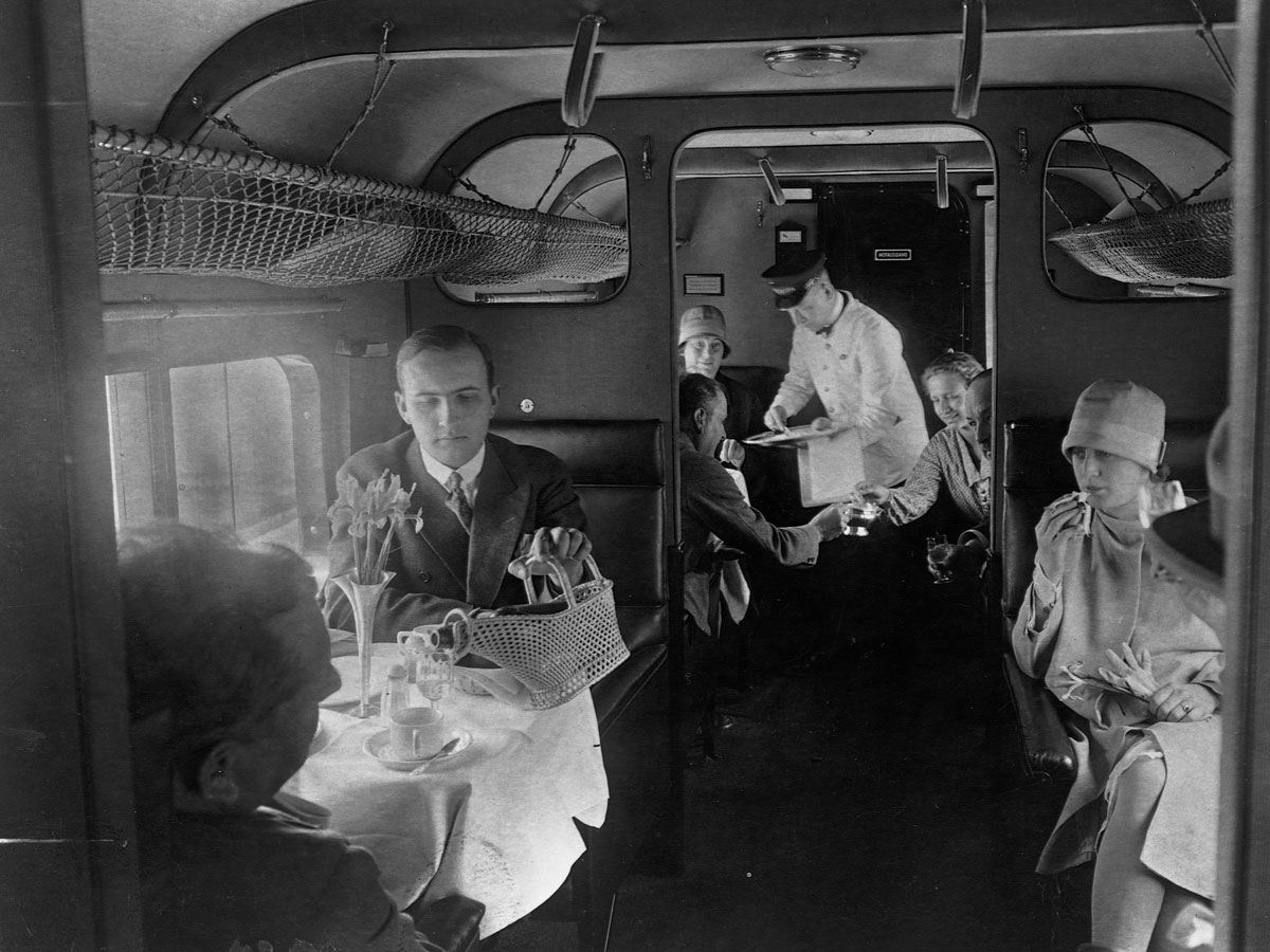 Archival image of passengers dining on Lufthansa flight in 1920