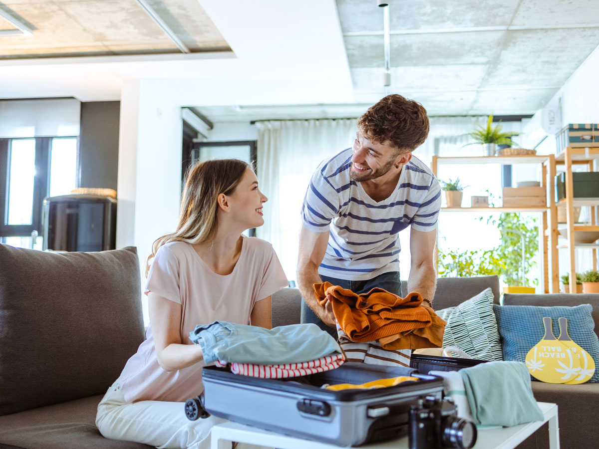 Couple packing for vacation