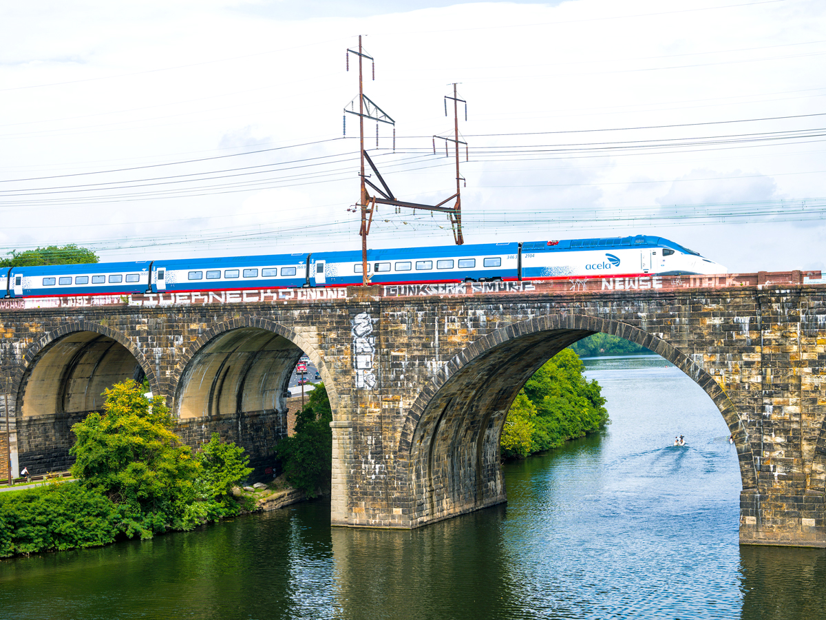 Amtrak train crossing bridge over river