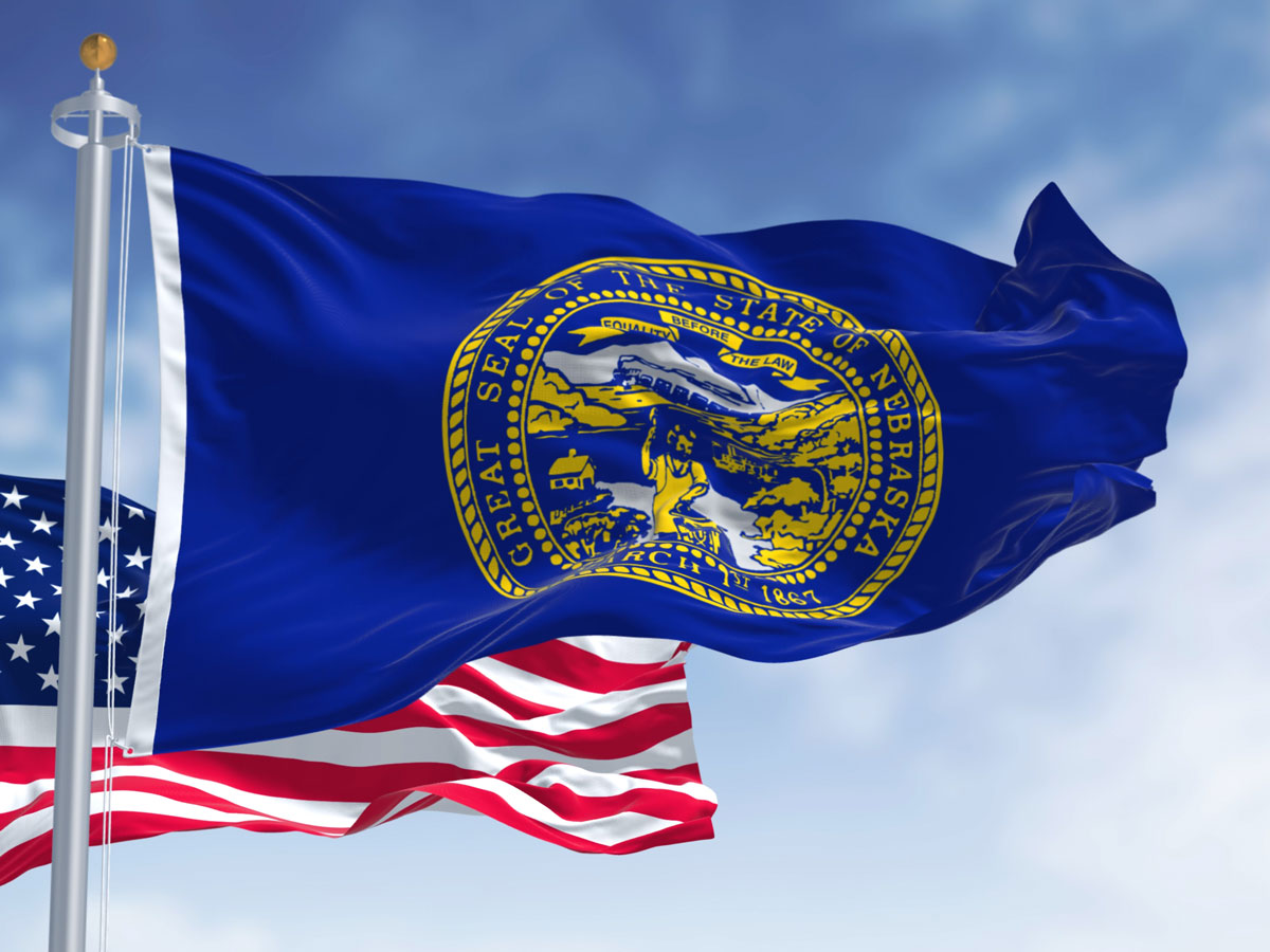 Nebraska flag flying beside American flag