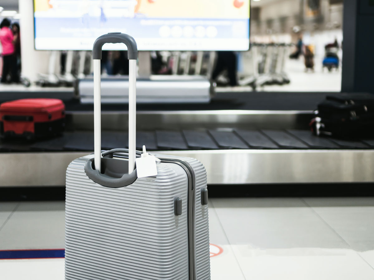 Roller bag beside carousel at airport