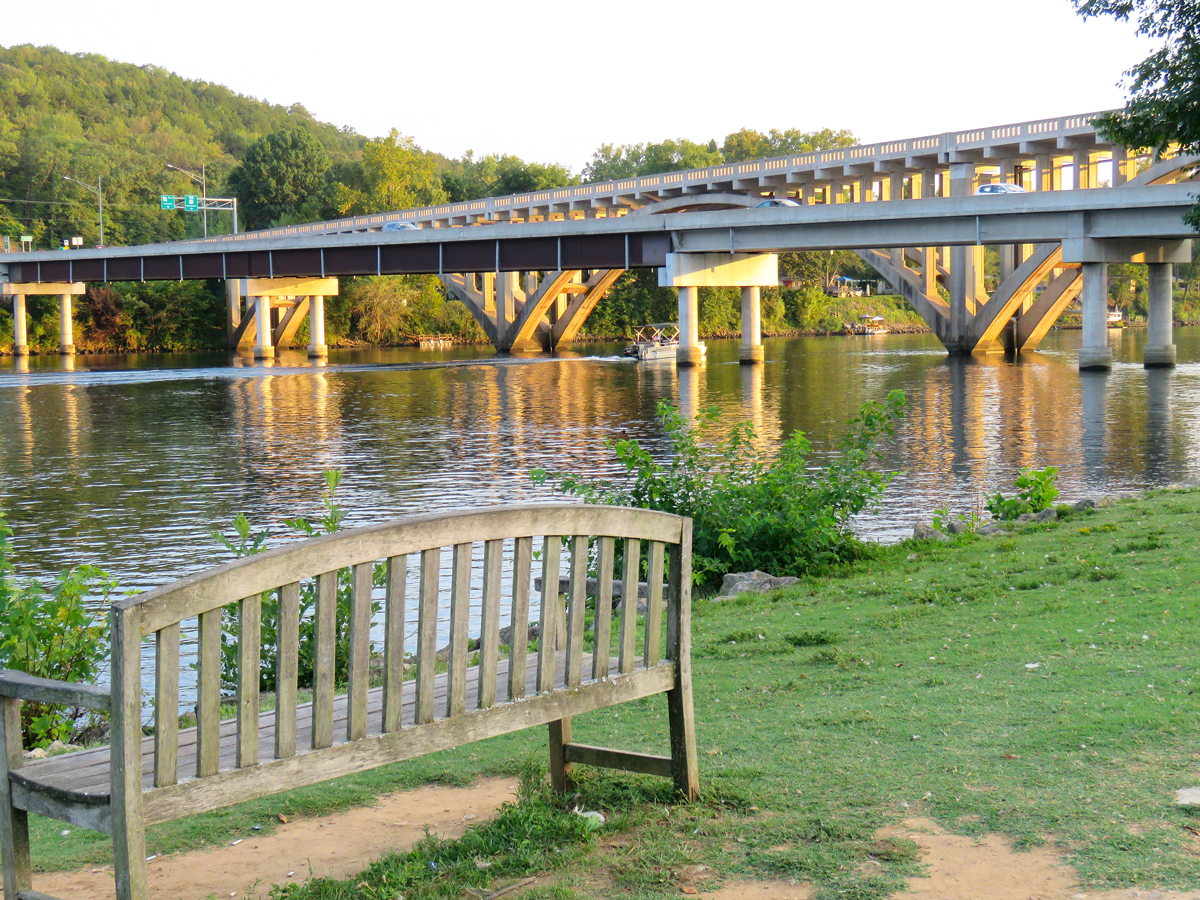 Bench beside bridge and river in Branson, Missouri