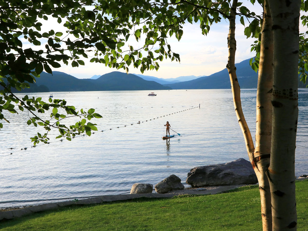 Stand-up paddle boarder off Whitefish City Beach in Montana