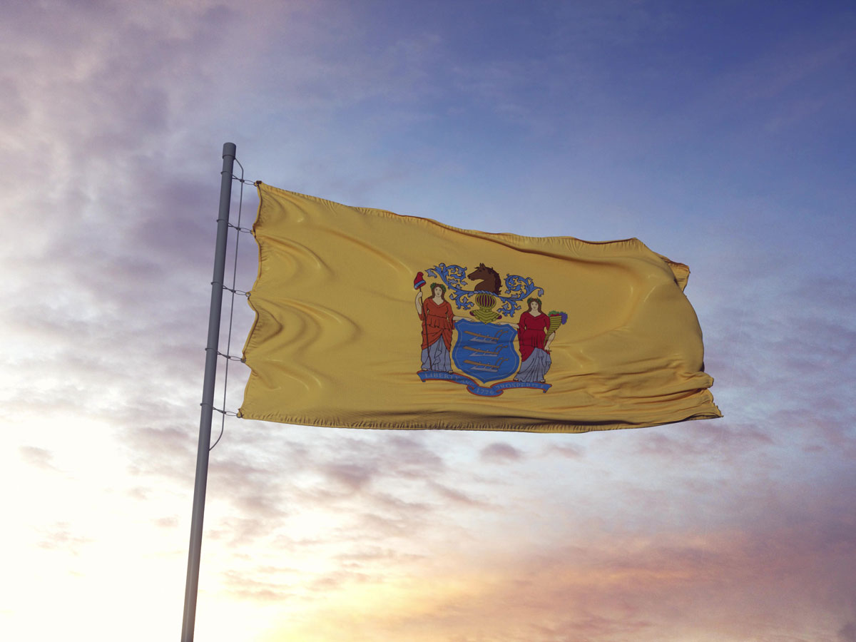 New Jersey flag with sunset in background