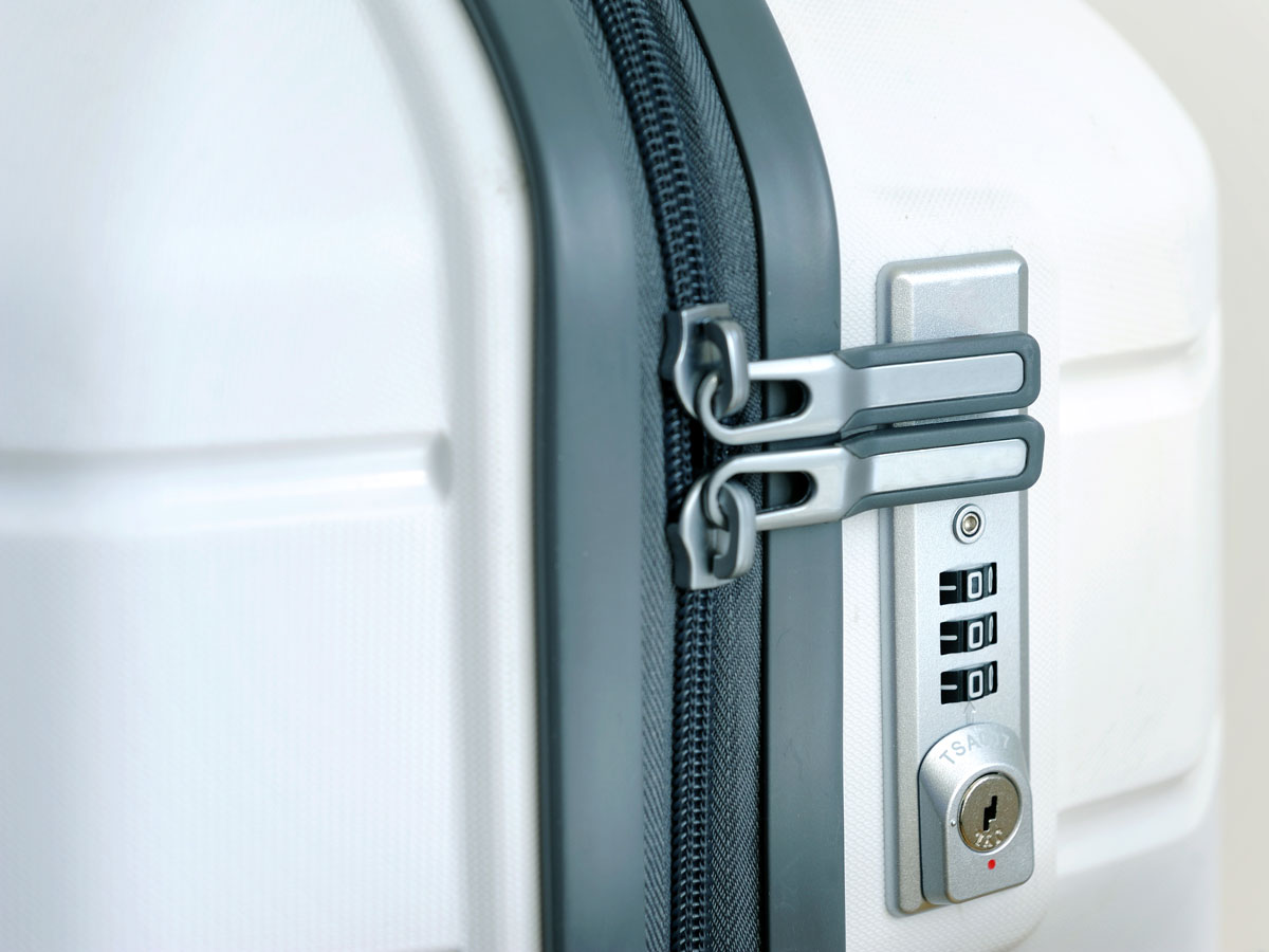 Close-up view of zipper and luggage lock on suitcase