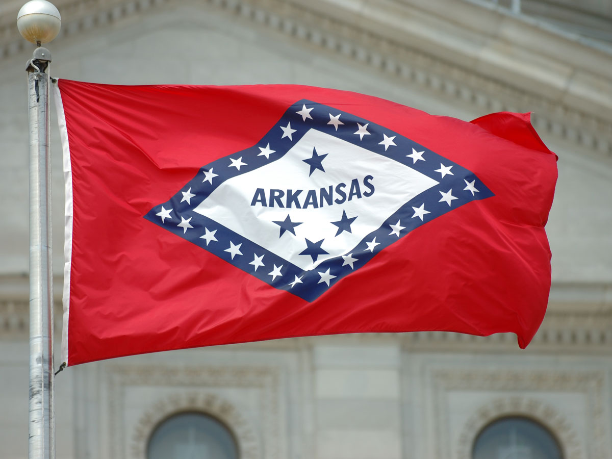 Arkansas flag with Capitol in background