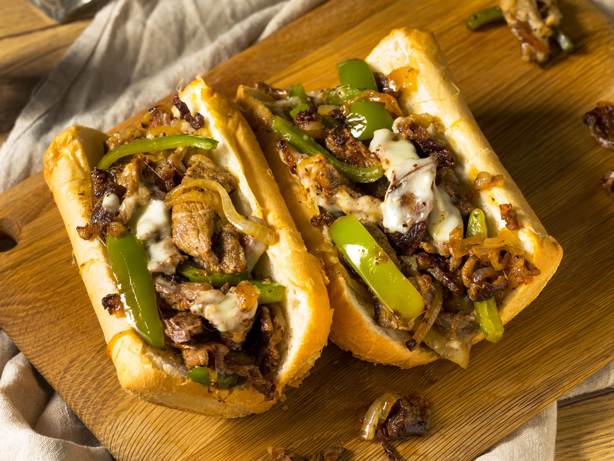 A cheesesteak on a cutting board