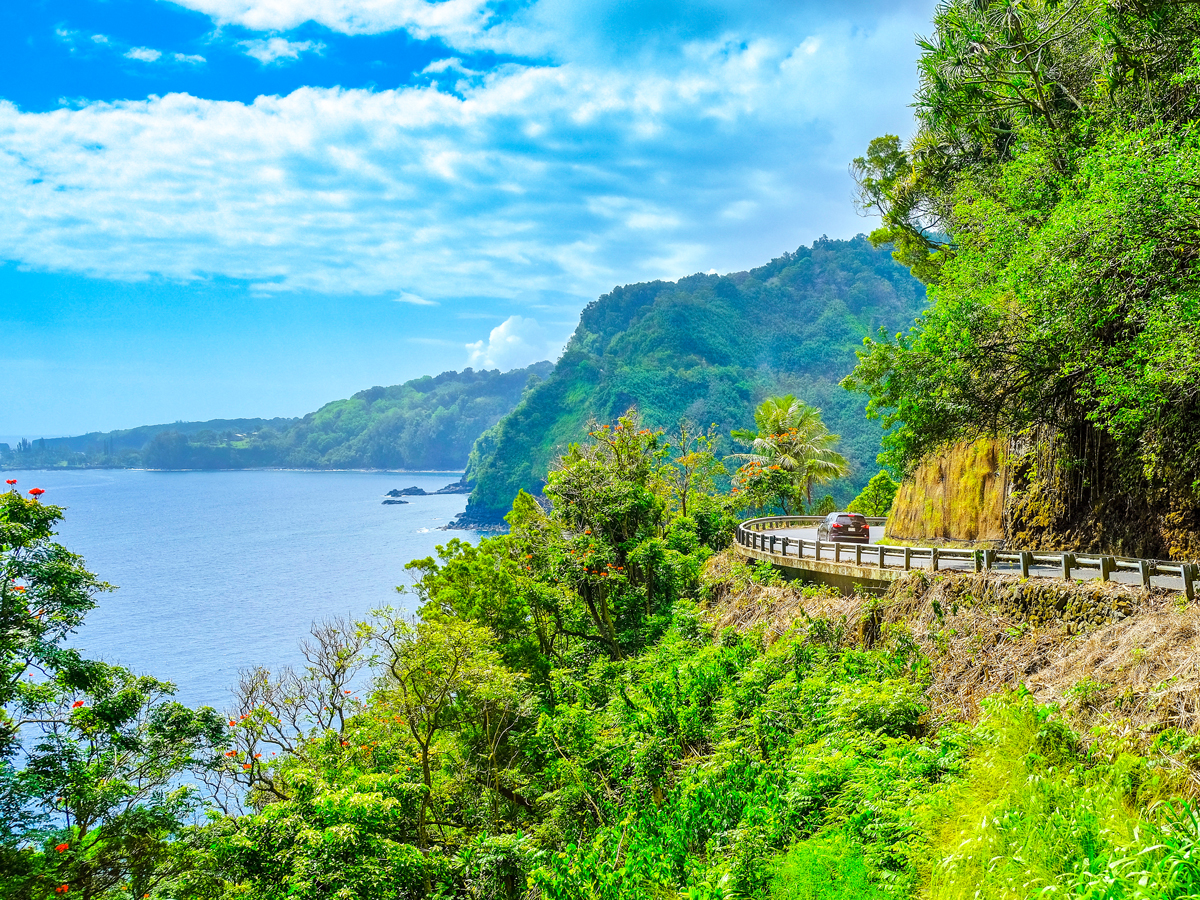 Car hugging cliffside on the Road to Hana
