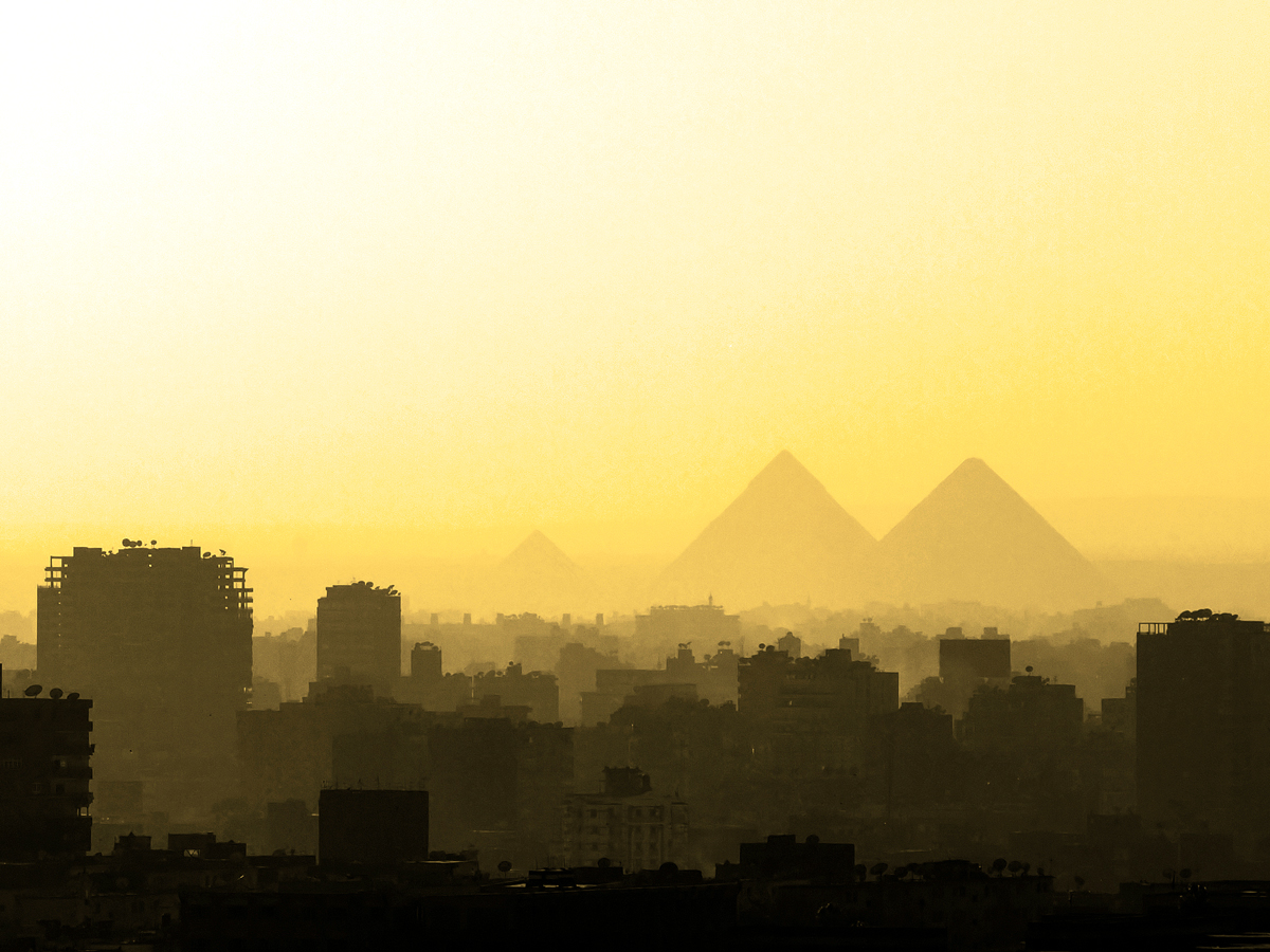 Skyline of Cairo, Egypt, on hazy day with Pyramids of Giza in distance