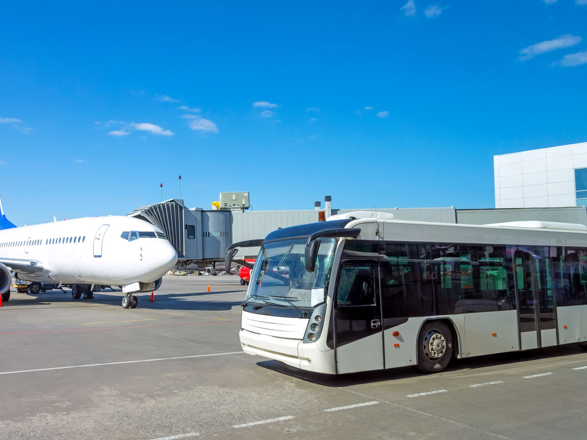 Bus next to airplane on airport tarmac