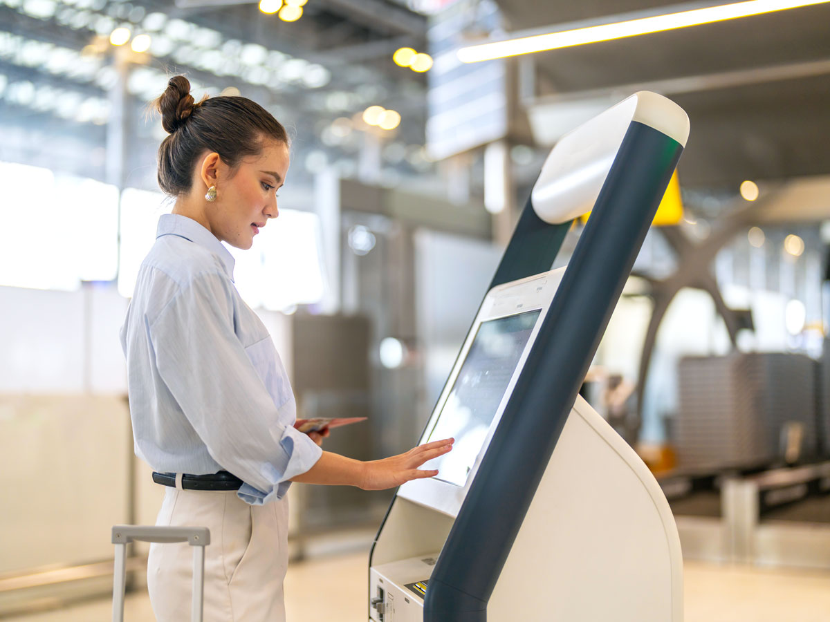 Passenger using kiosk to check in for flight