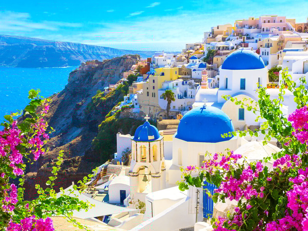 Traditional blue-and-white buildings overlooking the sea in village of Oia on island of Santorini