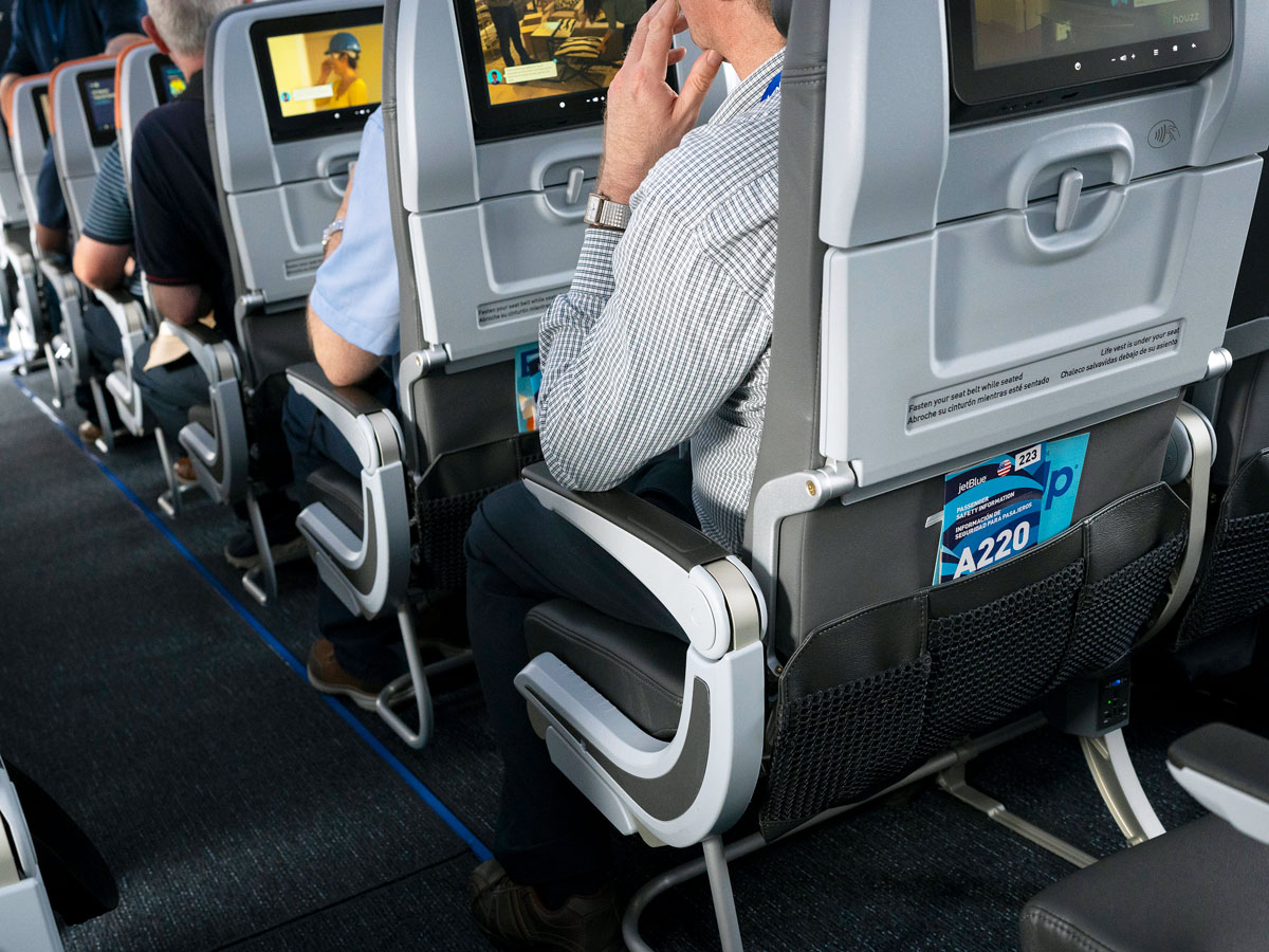 Passengers seated on JetBlue Airbus A220